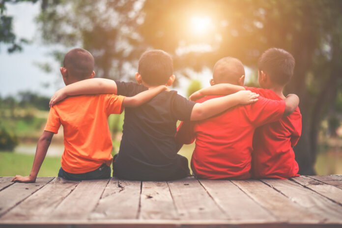 group kids friends arm around sitting together group kids friends arm around sitting together